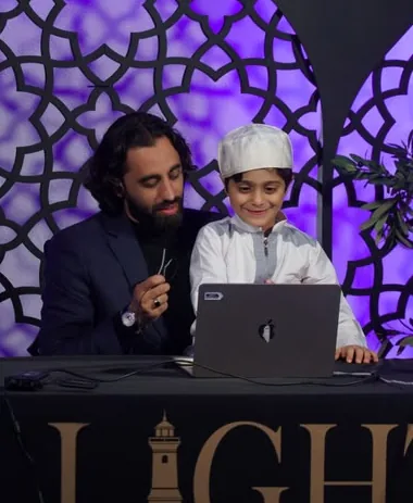 Dr. Ahmad Deeb with a young student at a Lighthouse event