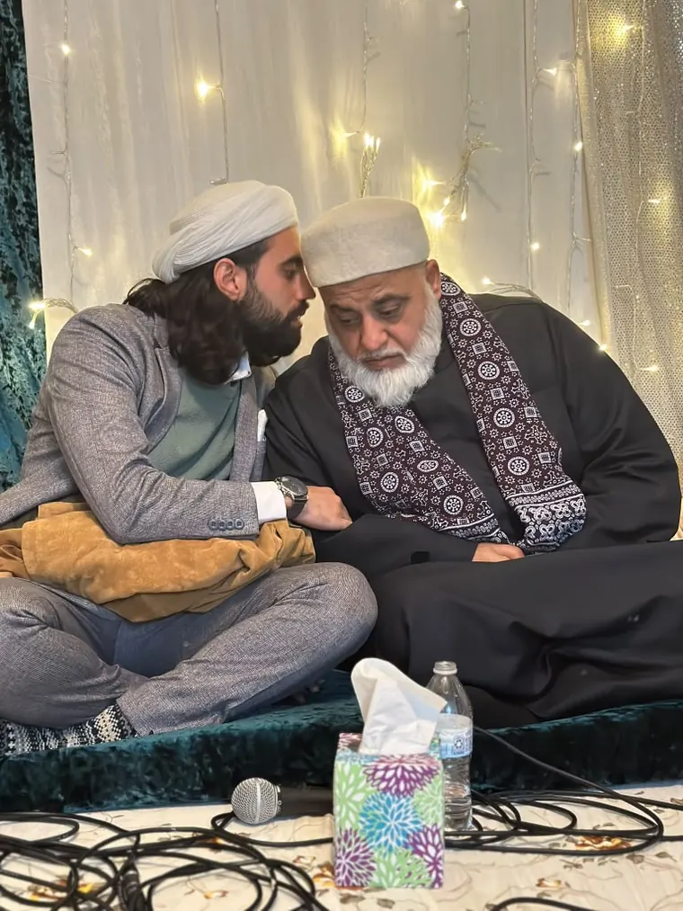 Dr. Ahmad Deeb sitting beside a shaykh at a gathering